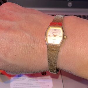 #506–Ladies(adjustable band) Gruen Gold tone watch with diamond on face.